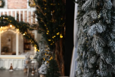 Photo of Stylish Christmas garland and festive decor indoors, selective focus. Interior design