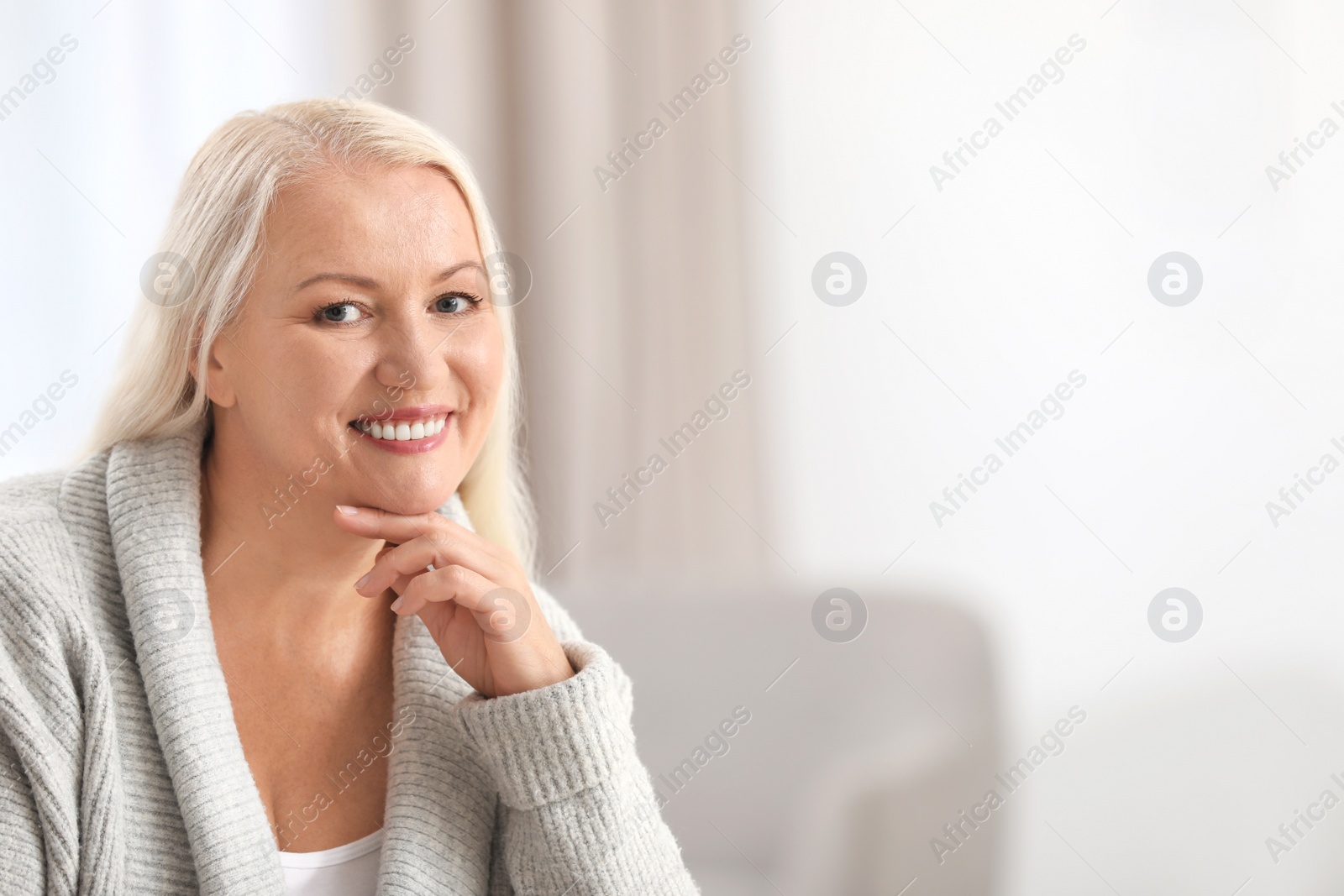 Photo of Portrait of beautiful older woman against blurred background with space for text