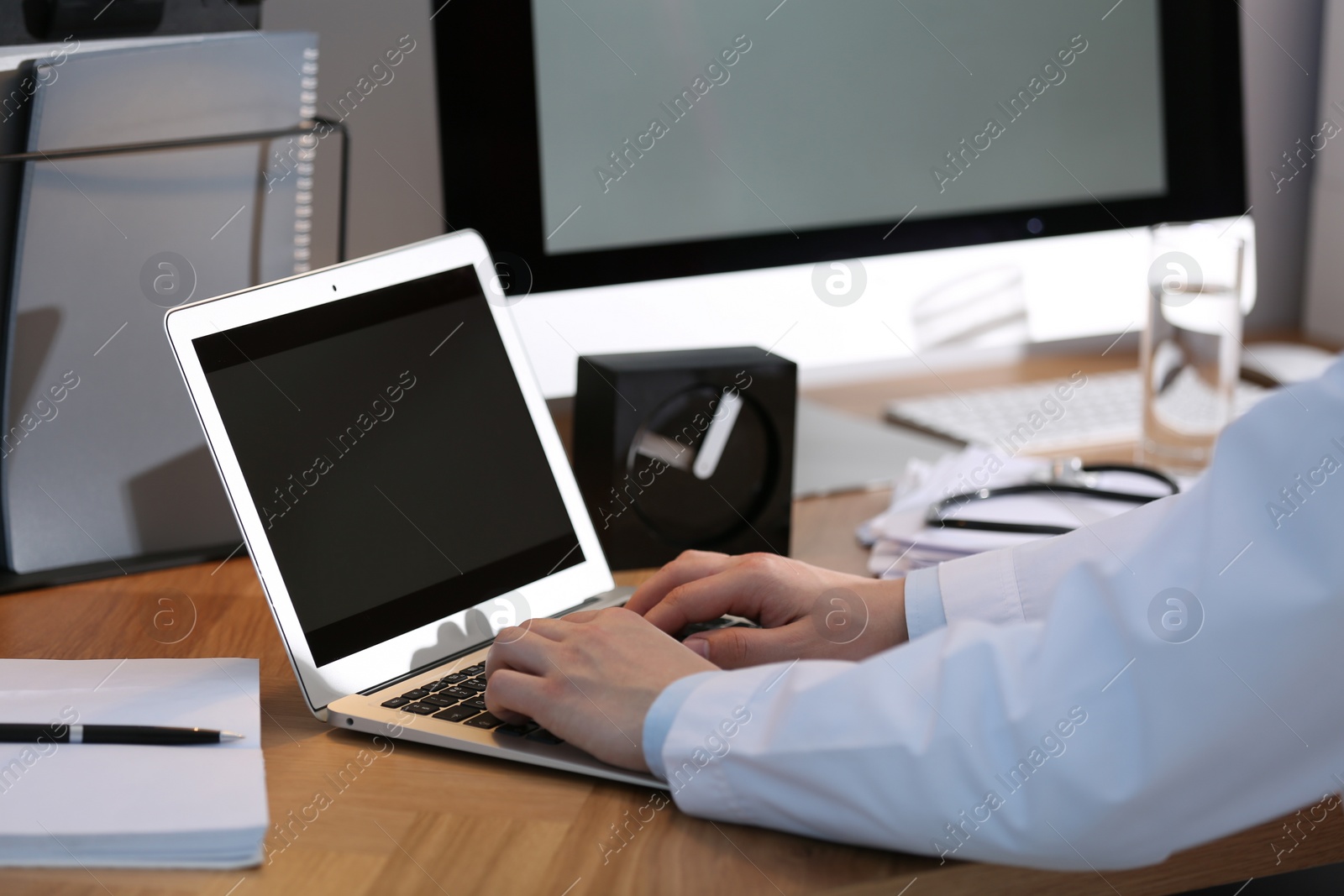 Photo of Professional doctor working on laptop in office, closeup