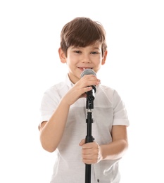 Cute little boy singing into microphone on white background