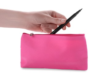 Photo of Woman taking eyeliner from pink cosmetic bag on white background, closeup
