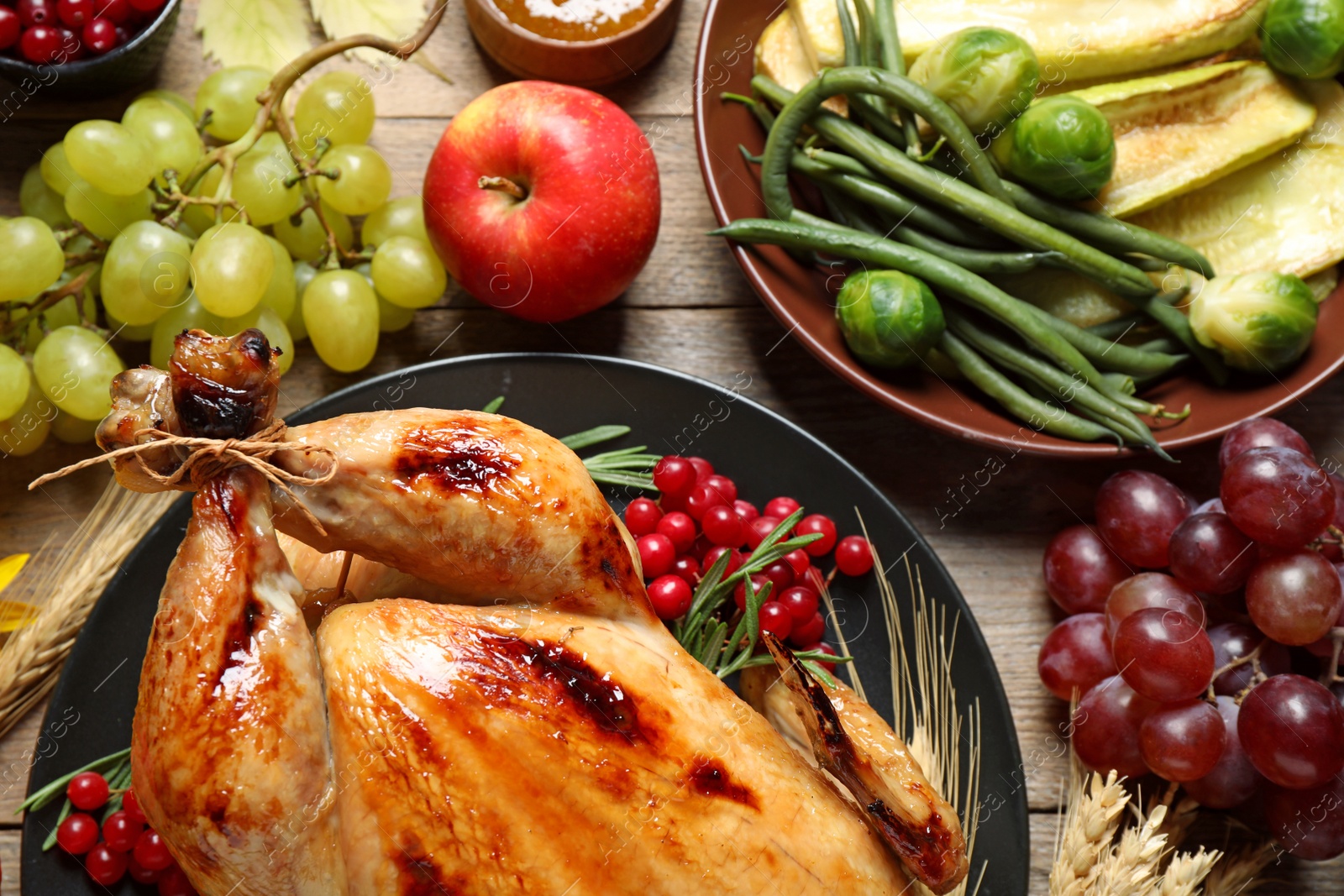 Photo of Flat lay composition with turkey on wooden background. Happy Thanksgiving day