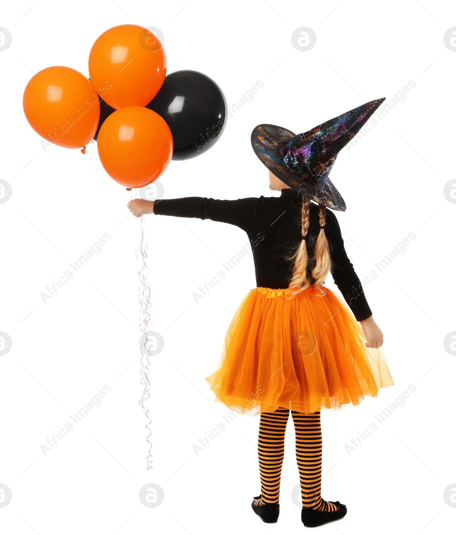 Photo of Cute little girl with balloons wearing Halloween costume on white background