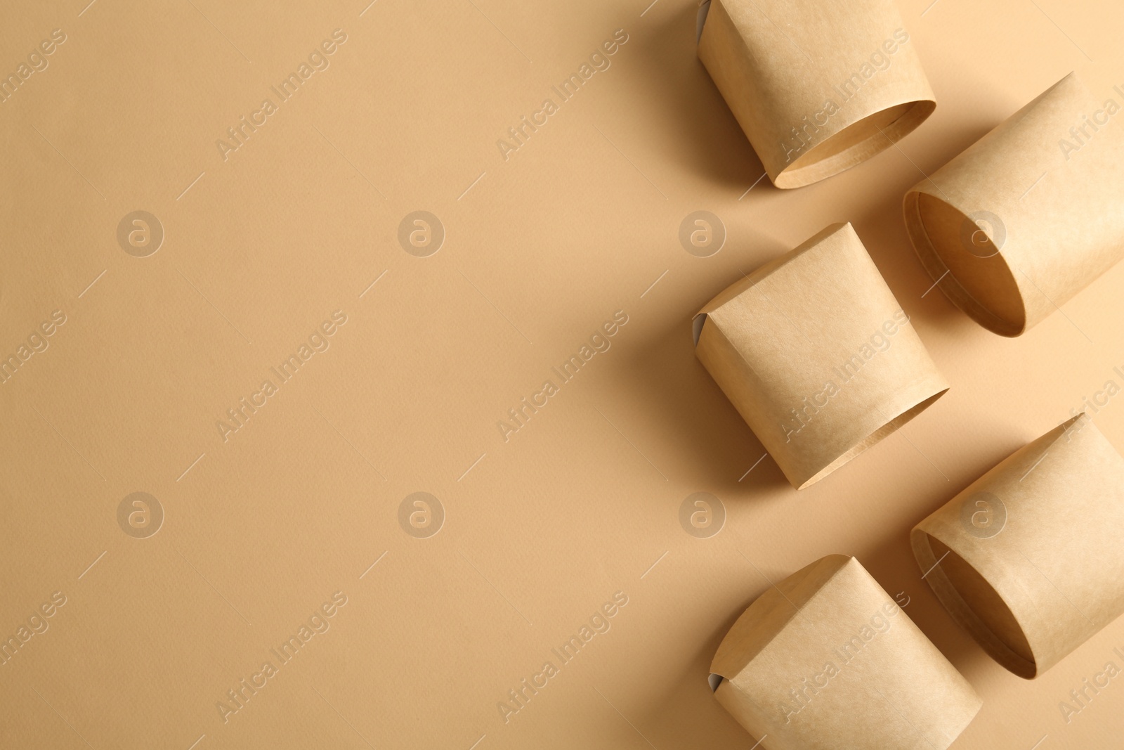 Photo of Eco friendly food containers and space for text on beige background, flat lay