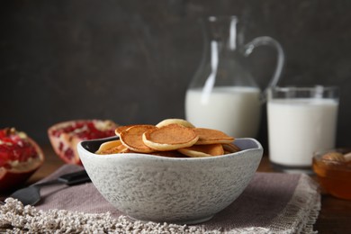 Photo of Delicious mini pancakes cereal served on table