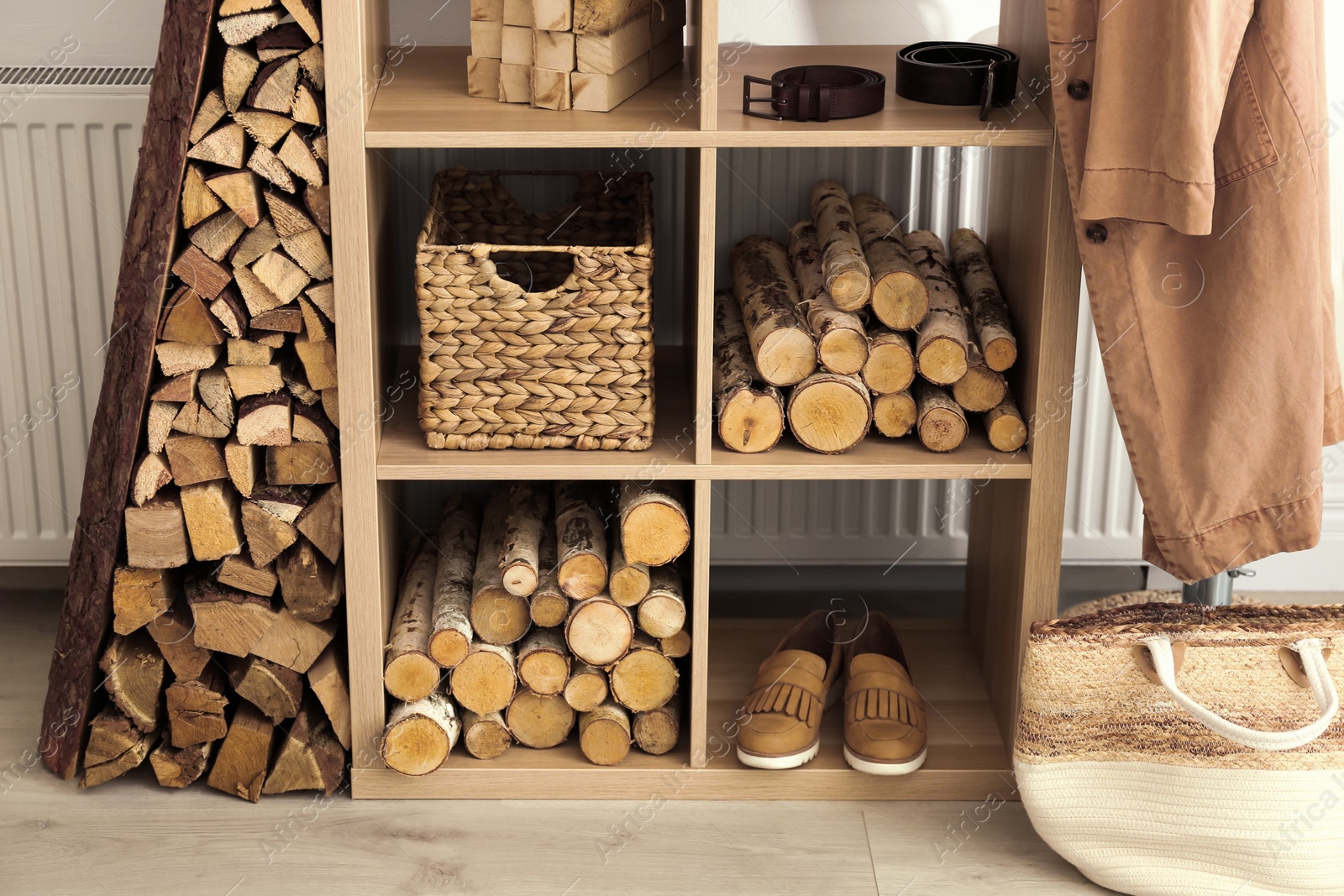 Photo of Stylish room interior with firewood as decorative element