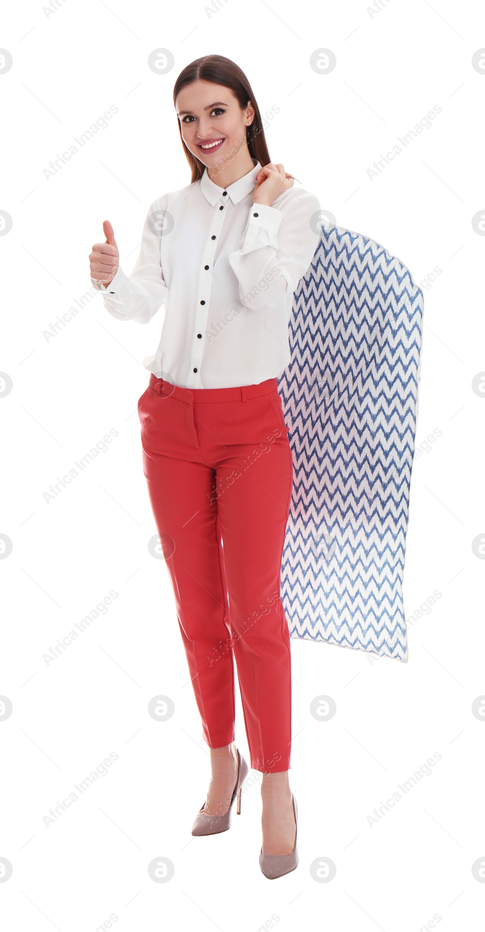 Photo of Young woman holding hanger with clothes in garment cover on white background. Dry-cleaning service