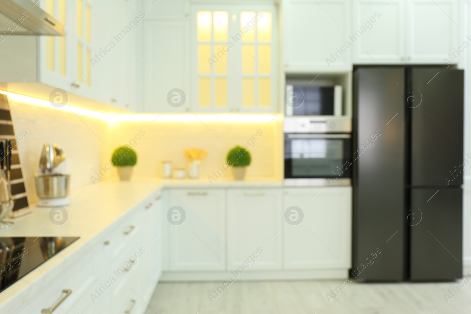 Photo of Blurred view of modern kitchen interior with stylish furniture