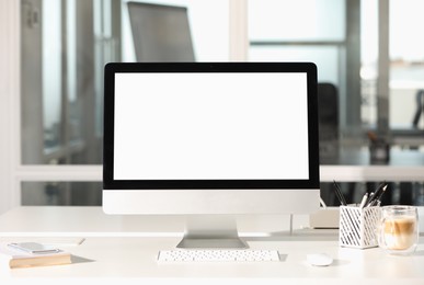 Photo of Modern computer on white desk in office. Mockup for design
