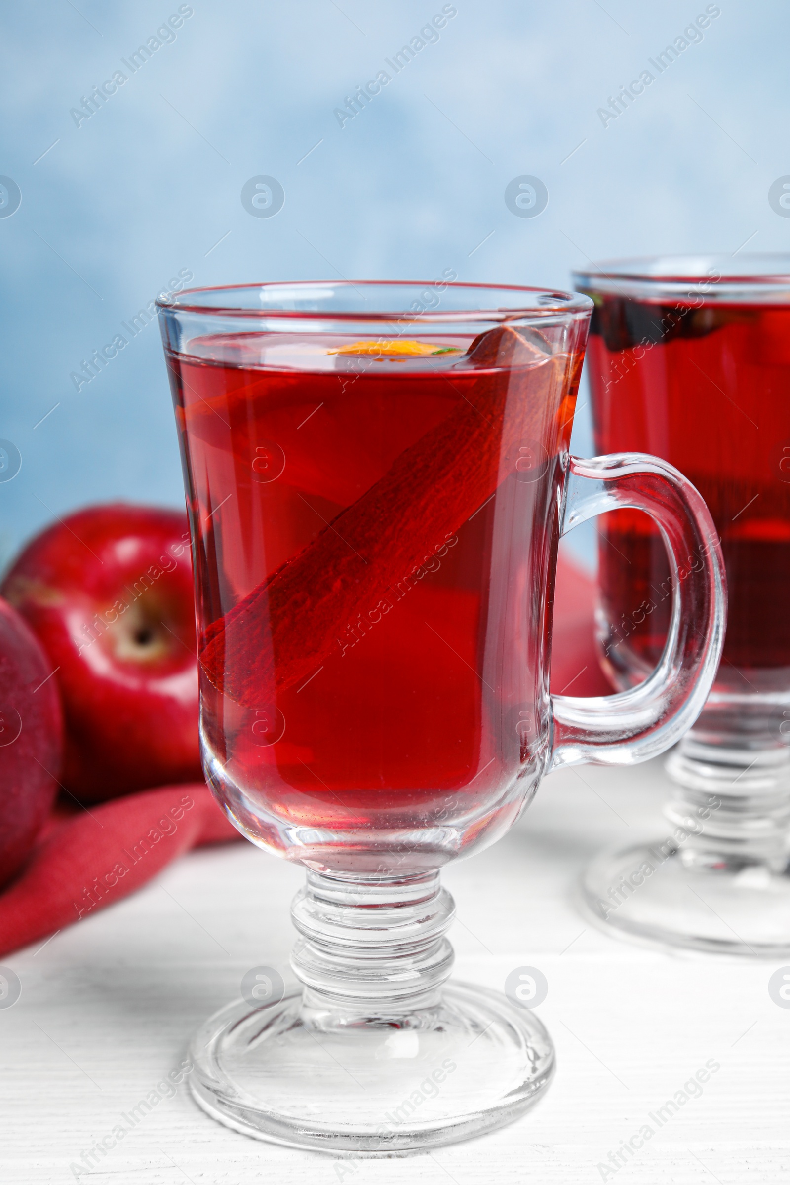 Photo of Tasty mulled wine with spices on white wooden table