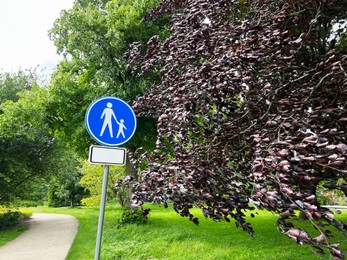 Road sign Footpath in park on sunny day