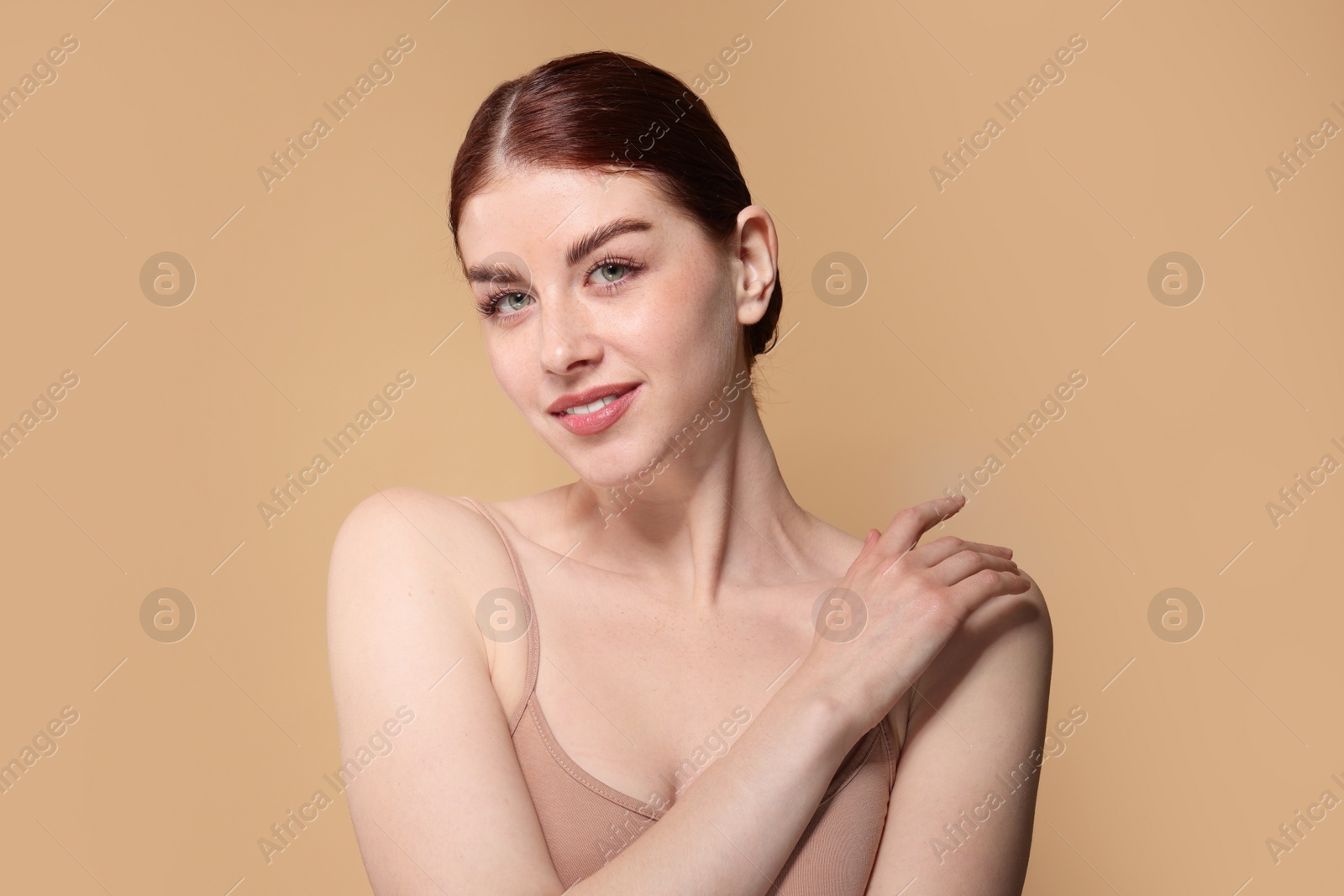 Photo of Portrait of beautiful woman on beige background