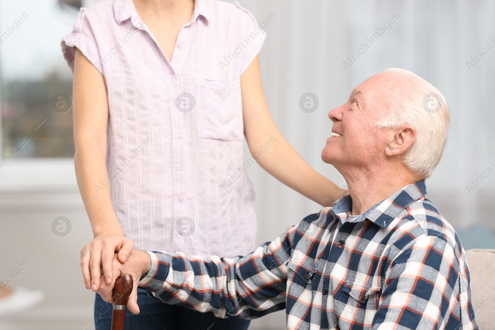 Photo of Elderly man with female caregiver at home