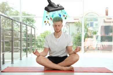 Purification of mind. Vacuum cleaner extracting bad thoughts from meditating man indoors