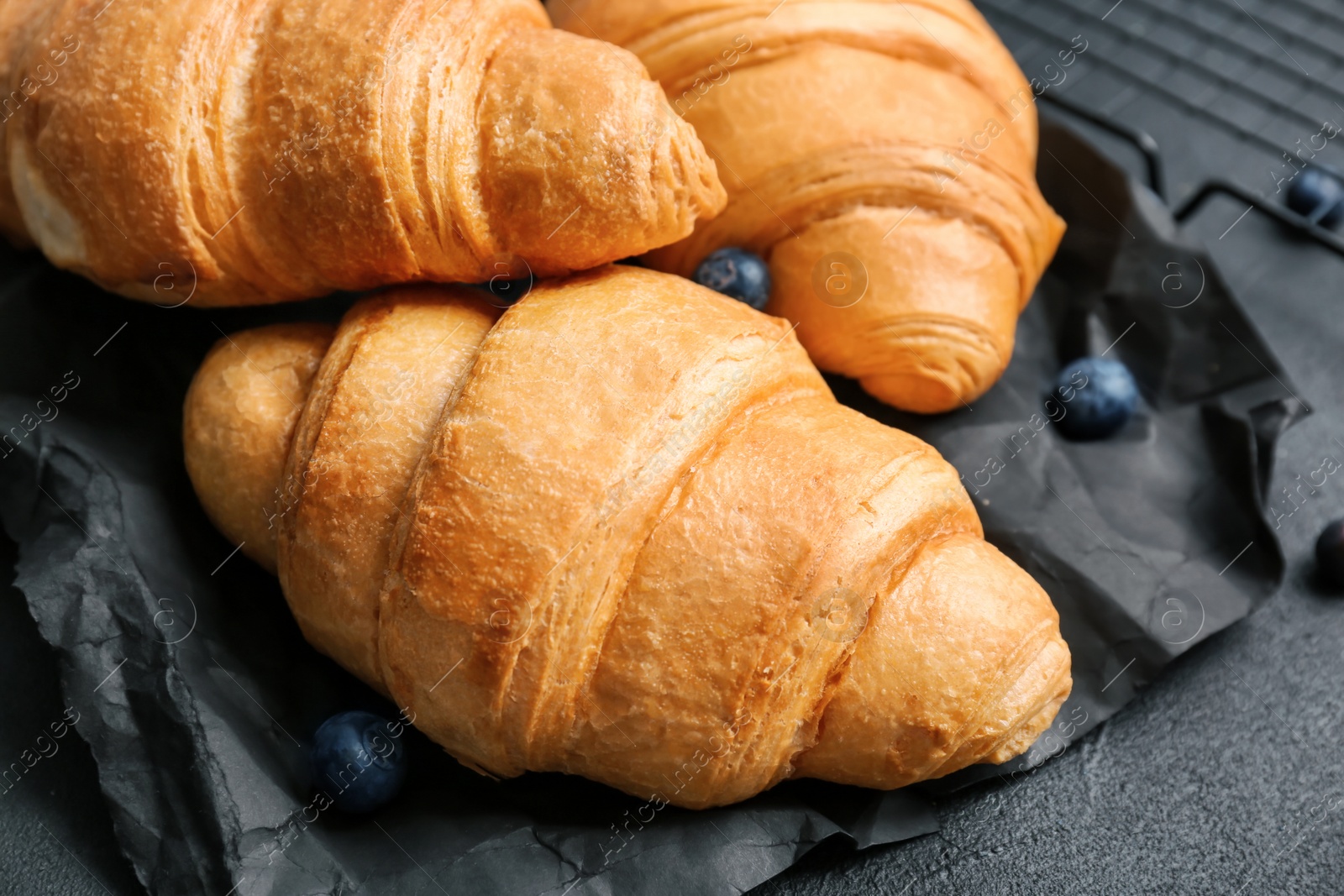 Photo of Tasty croissants on table, closeup