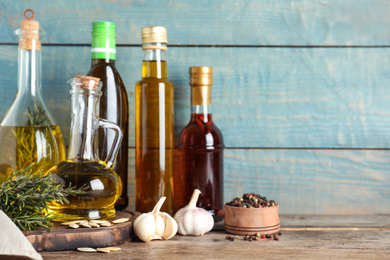 Different cooking oils in bottles on wooden table