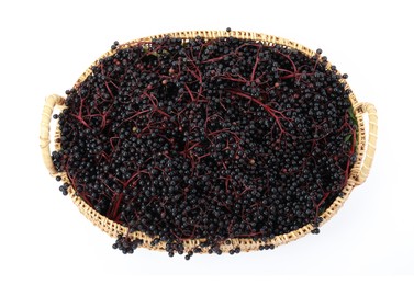 Photo of Wicker basket with ripe elderberries isolated on white, top view