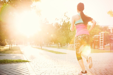 Young woman on morning run in park