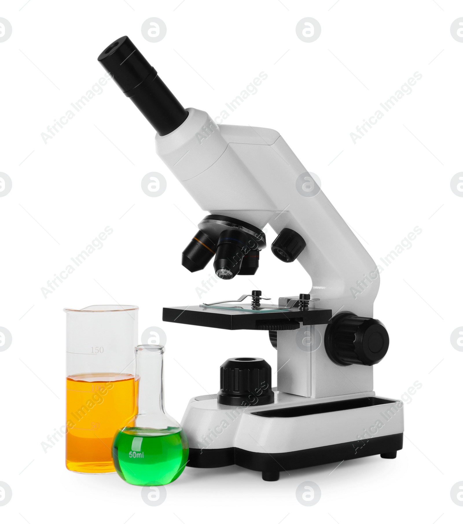 Photo of Laboratory glassware with colorful liquids and microscope isolated on white