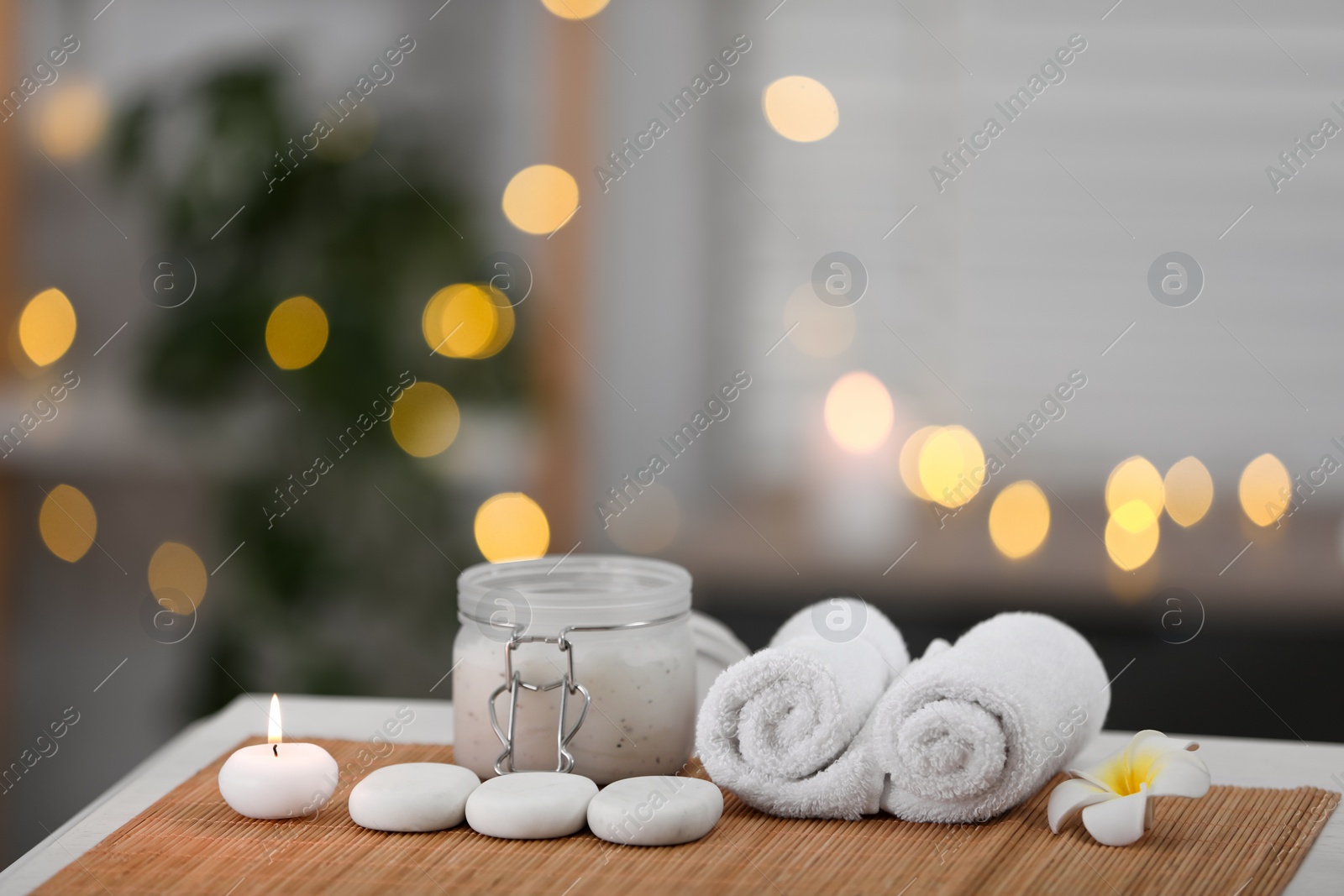 Photo of Composition with spa stones and cosmetic product on table indoors, space for text