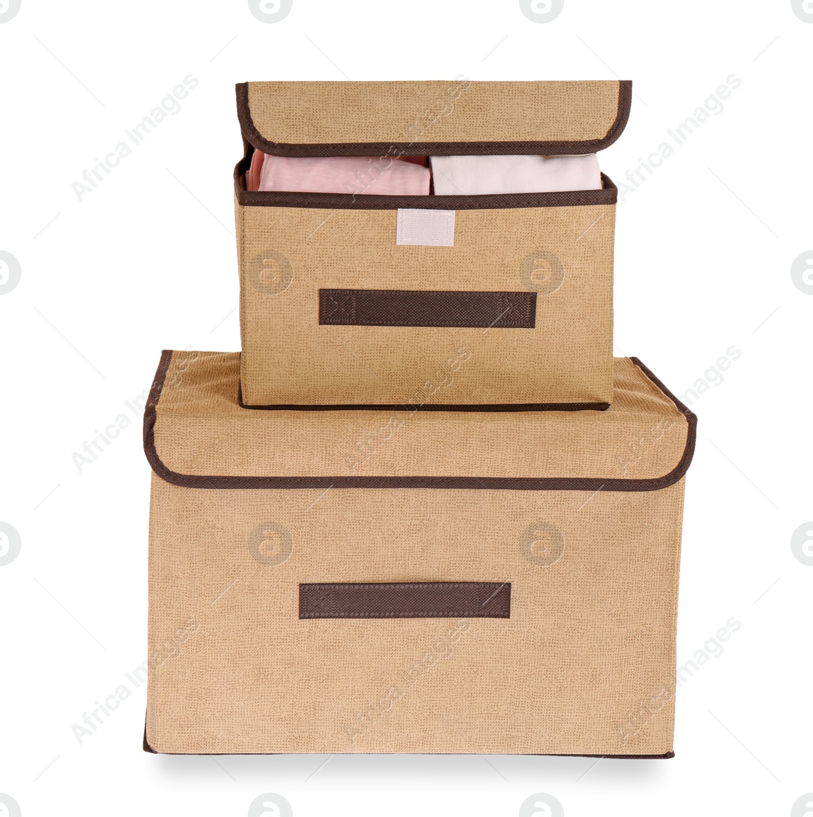 Photo of Textile storage cases with folded clothes on white background