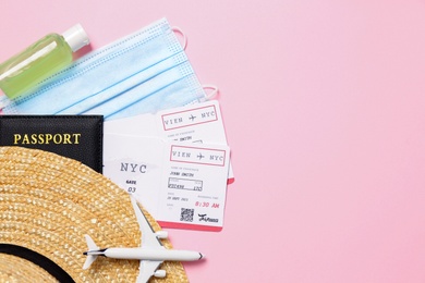 Photo of Flat lay composition with passport and protective mask on pink background, space for text. Travel during quarantine