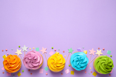 Photo of Colorful birthday cupcakes on lilac background, flat lay. Space for text