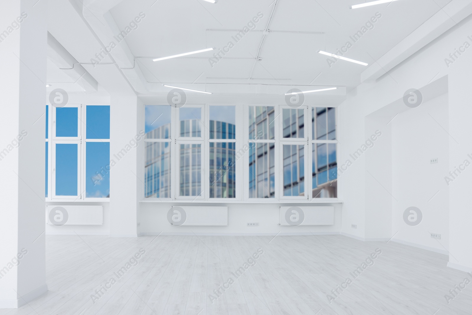 Photo of Empty room with white walls and beautiful windows during repair