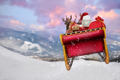 Magic Christmas eve. Santa with reindeers outdoors on snowy winter day, space for text