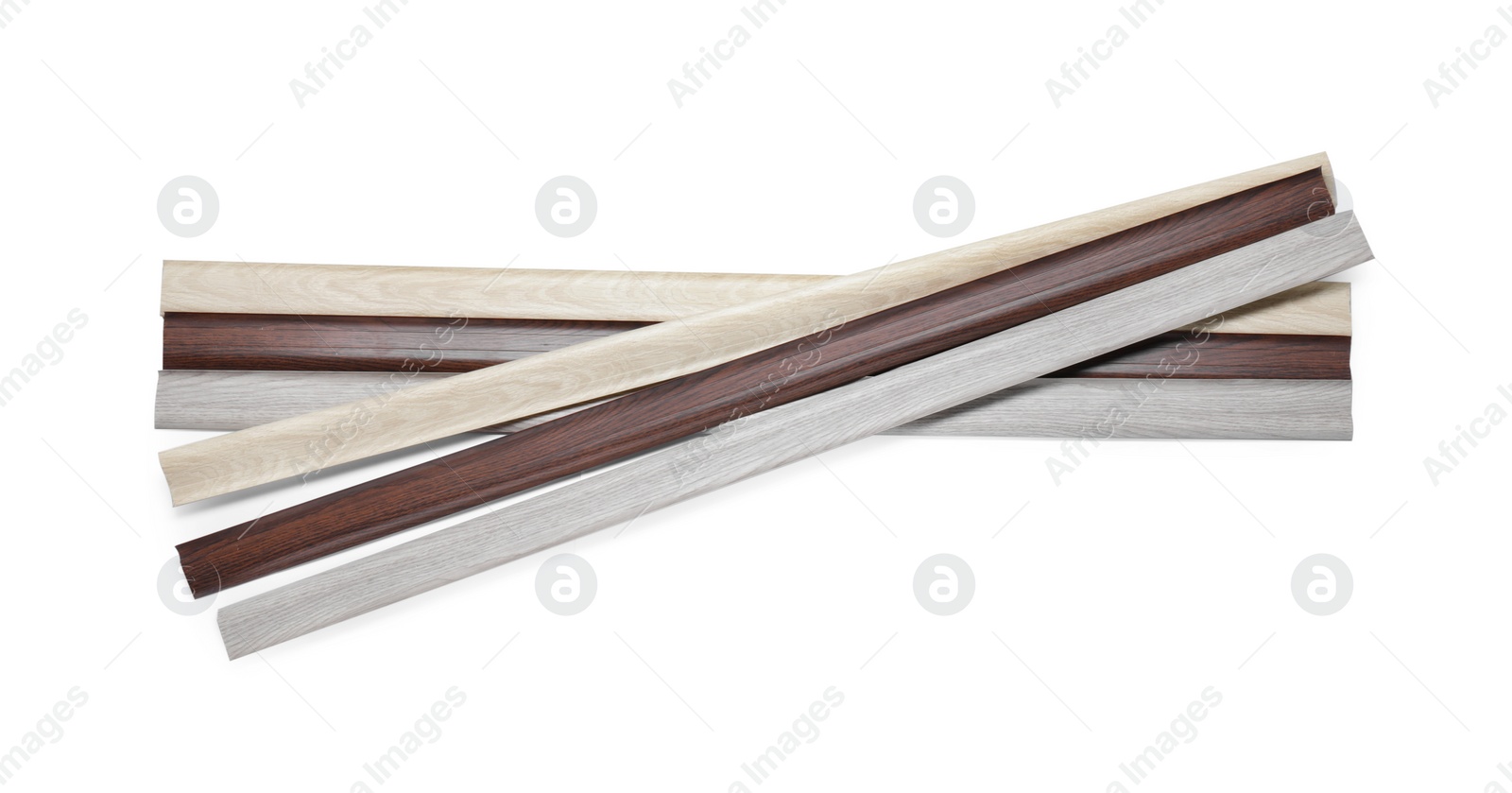 Photo of Many pieces of wooden baseboards isolated on white, top view