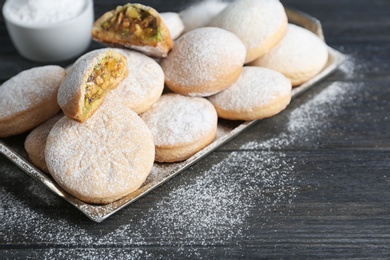 Photo of Traditional Islamic cookies on wooden table, space for text. Eid Mubarak