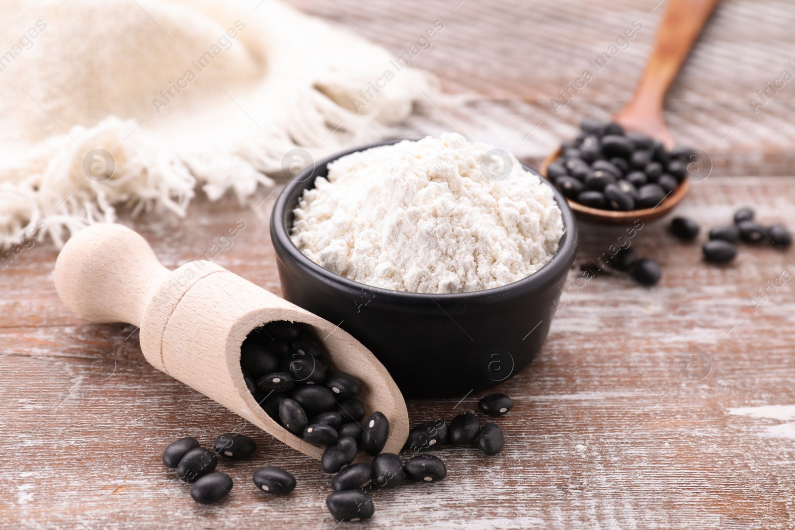 Photo of Bean flour and seeds on wooden table