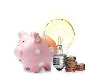 Image of Light bulb with tungsten filament in shape on house roof, piggy bank and coins on white background. Energy efficiency, loan, property or business idea concepts