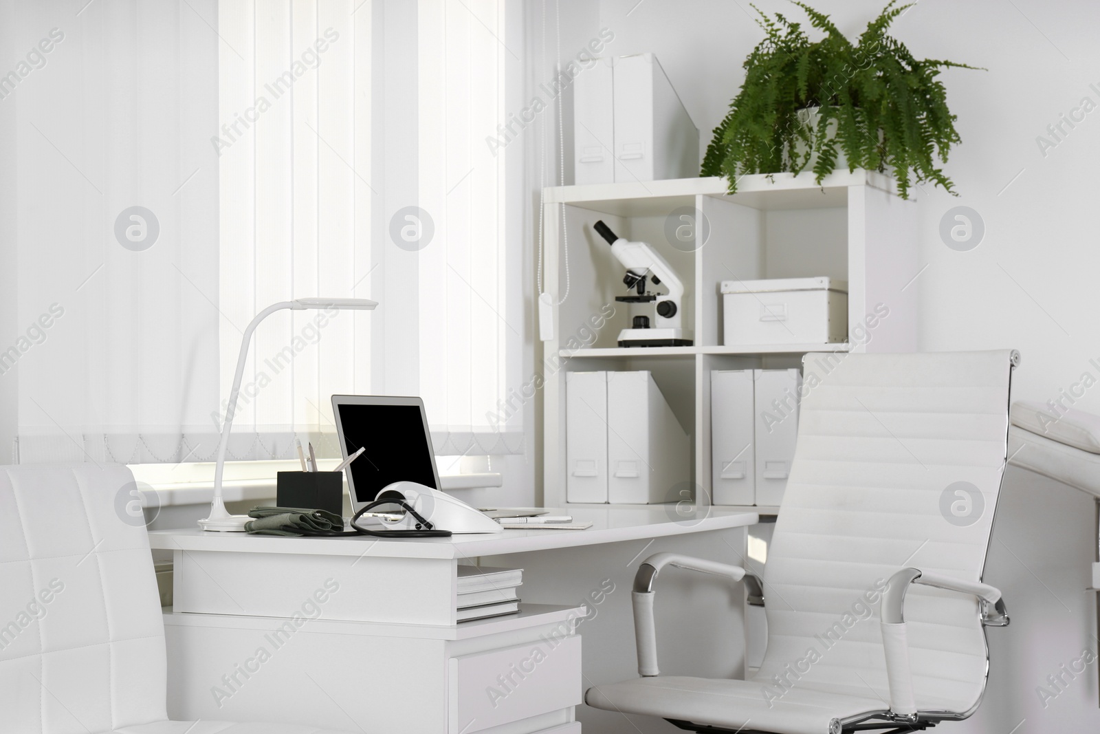 Photo of Doctor's workplace near window in medical office