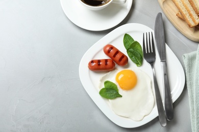 Photo of Delicious breakfast with fried egg served on table, flat lay. Space for text