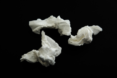 Photo of Used white paper tissues on black background