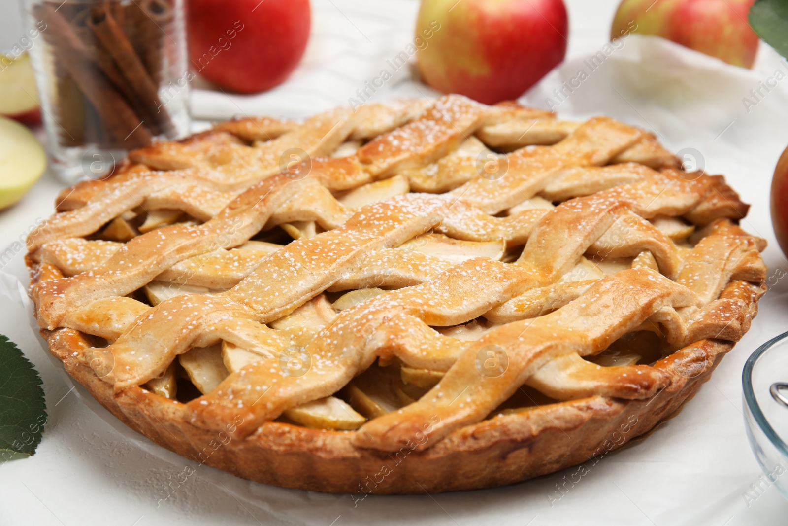 Photo of Delicious traditional apple pie on white table, closeup