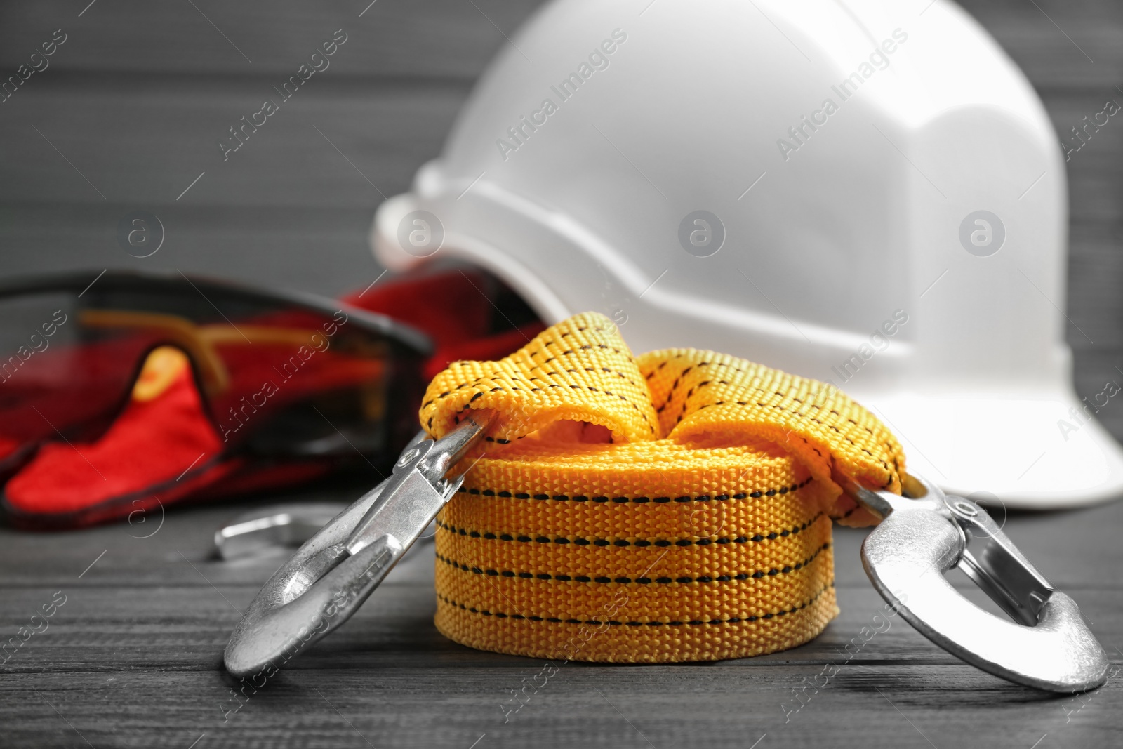 Photo of Yellow rope and blurred safety equipment on background. Space for text