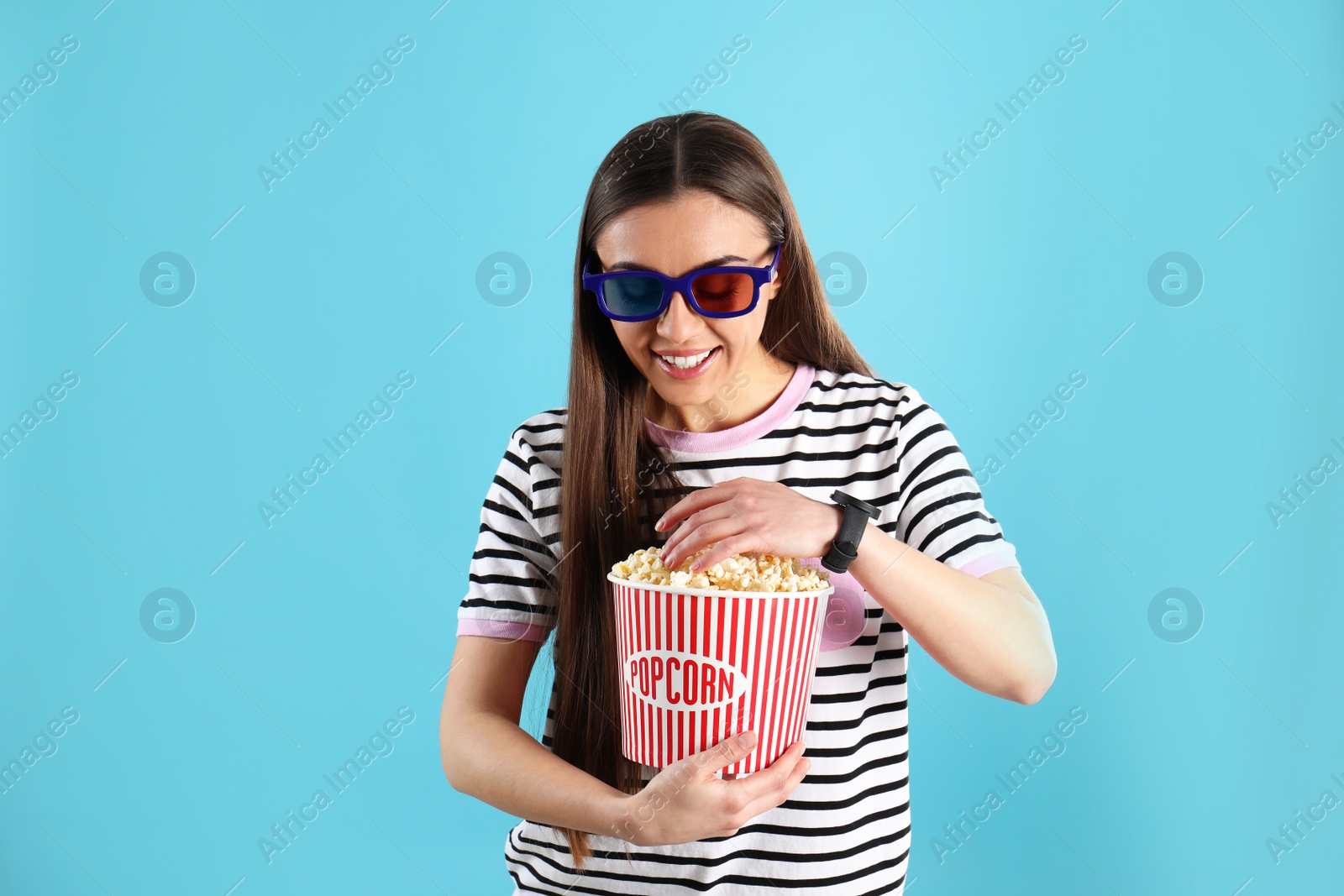 Photo of Young woman with 3D glasses and tasty popcorn on color background