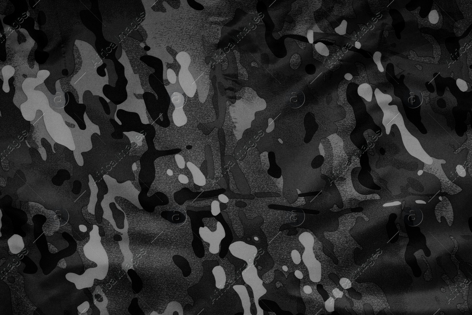 Image of Texture of crumpled camouflage fabric as background, top view. Black and white effect