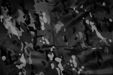 Image of Texture of crumpled camouflage fabric as background, top view. Black and white effect