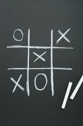 Tic tac toe game drawn on chalkboard, top view