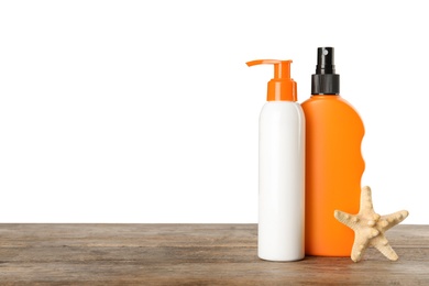 Bottles of sun protection products and starfish on table against white background