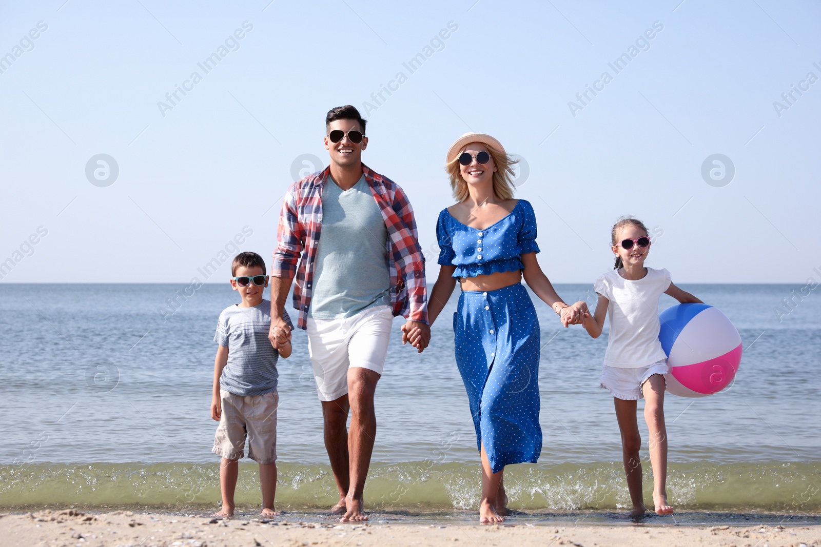 Photo of Happy family at beach on sunny summer day