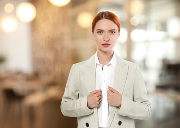 Image of Portrait of confident woman in office. Pretty girl on blurred background, space for text
