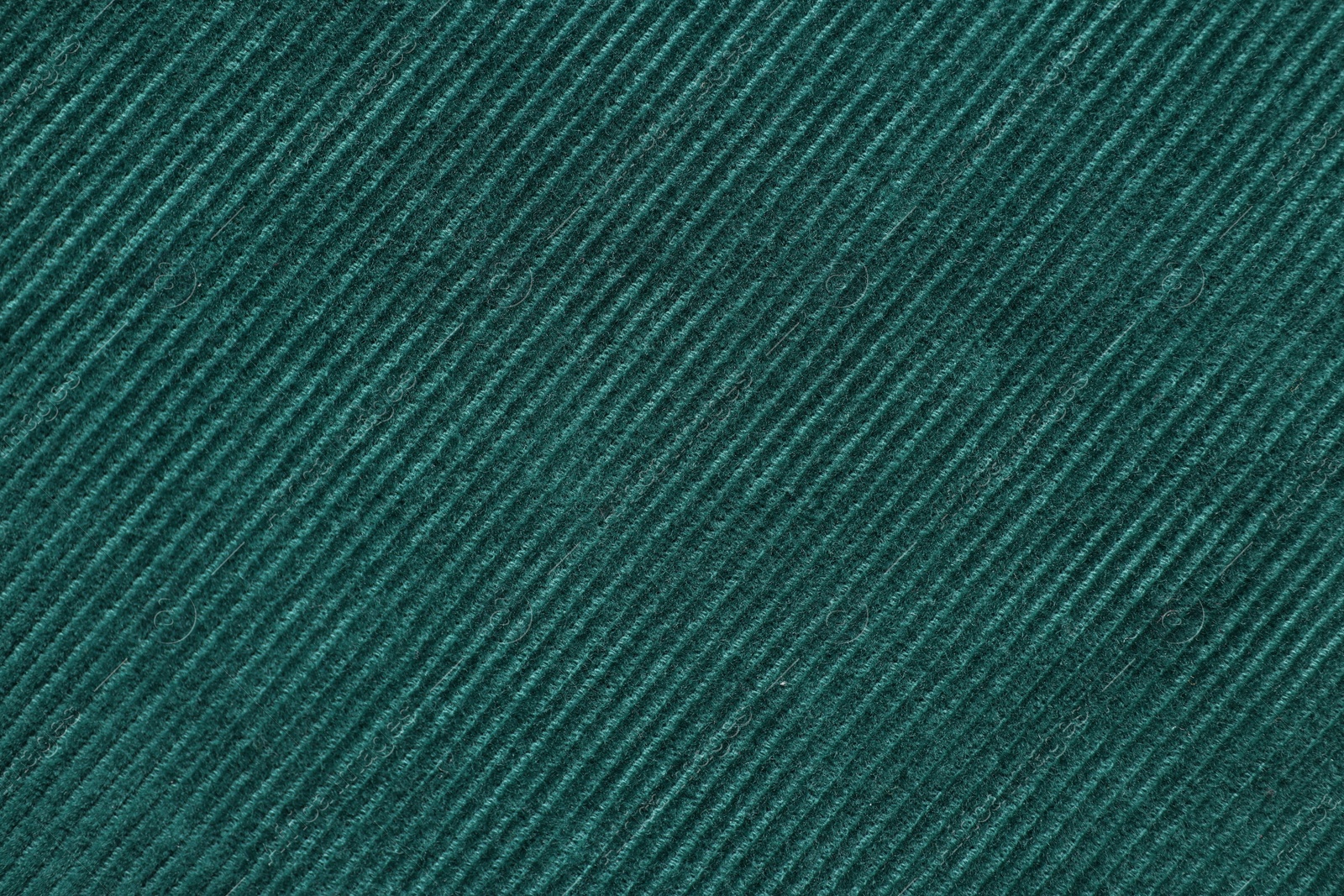 Photo of Texture of dark green fabric as background, top view