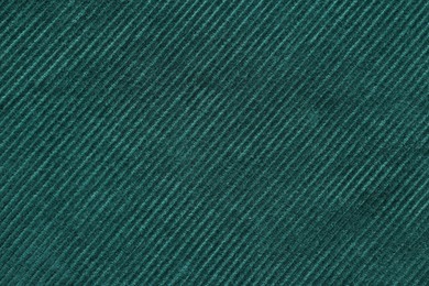 Photo of Texture of dark green fabric as background, top view