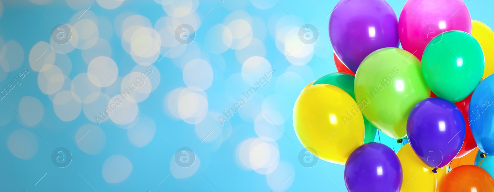 Image of Bright balloons on color background with bokeh effect, space for text. Banner design