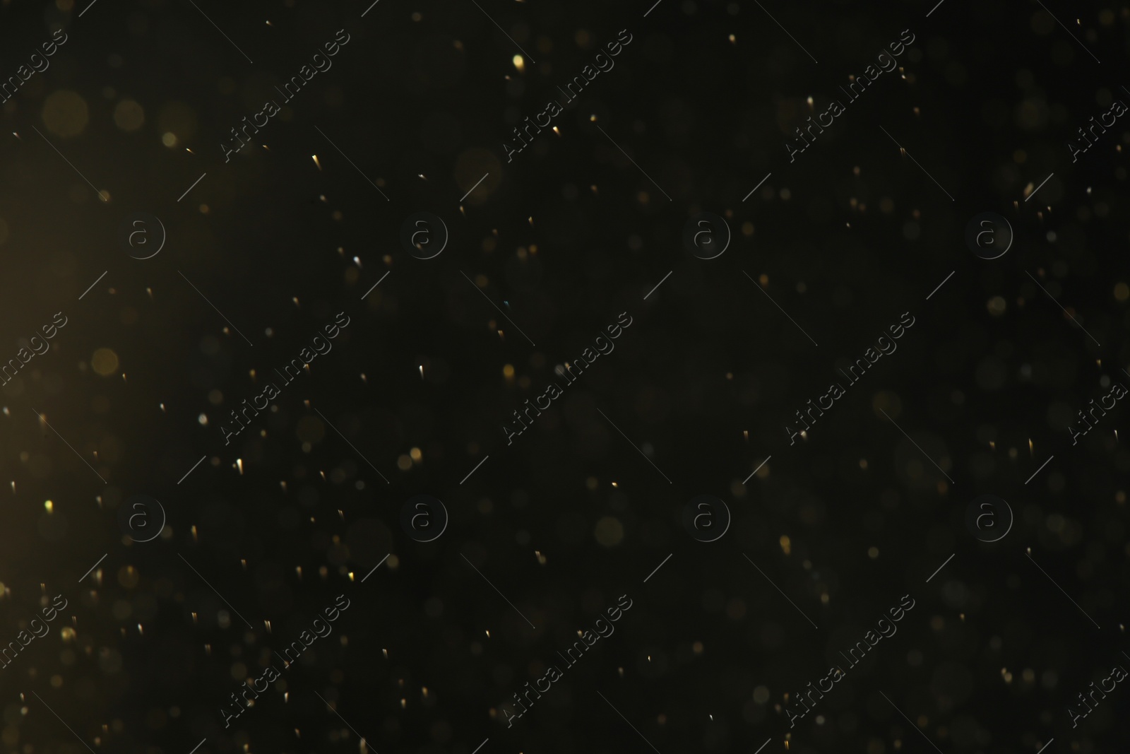 Photo of Magic golden bokeh effect on dark background