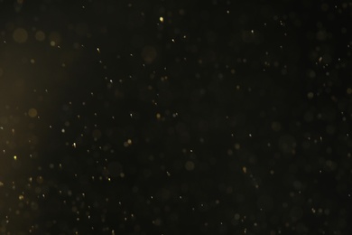 Photo of Magic golden bokeh effect on dark background